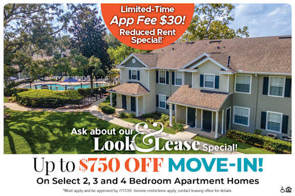 A house with a sign offering a $250 off move-in costs for select 2 bedroom apartment homes.