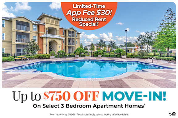 A large apartment complex with a pool advertising a limited time app fee and move-in special.