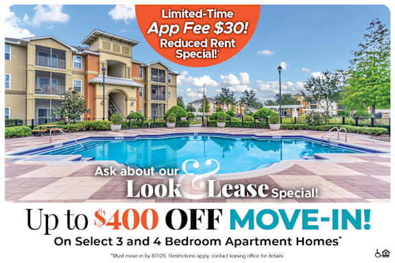 A large apartment complex with a pool advertises a limited-time app fee reduction and a move-in special.