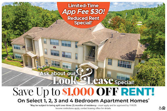 A large apartment complex advertises a limited-time app fee reduction and a move-in special.