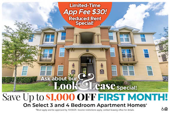 A large apartment complex advertises a limited-time app fee reduction and a special look and lease offer.