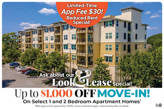 A large apartment complex advertises a limited-time app fee reduction and a move-in special.
