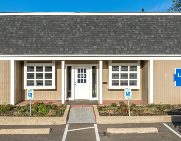 A building with a parking lot in front of it.