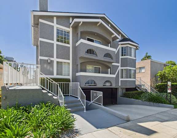 A modern two-story house with a balcony and a garage.
