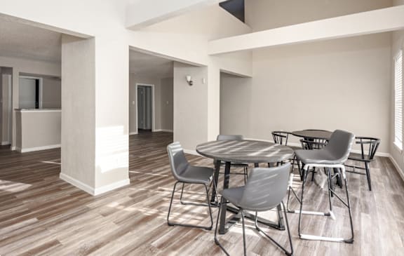A dining room with a round table and chairs.