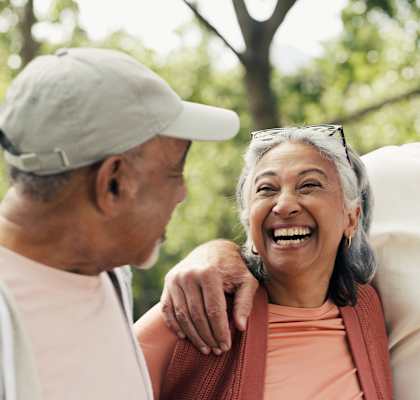 Four older adults enjoying a sunny day outdoors.