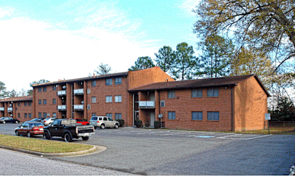 a large brick building with cars parked in front of it