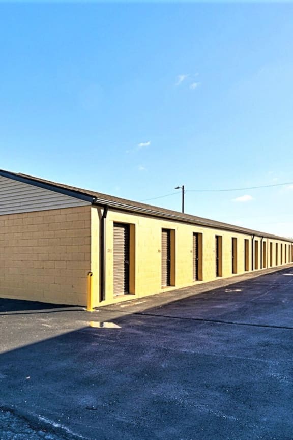 a long yellow building with a blue sky in the background