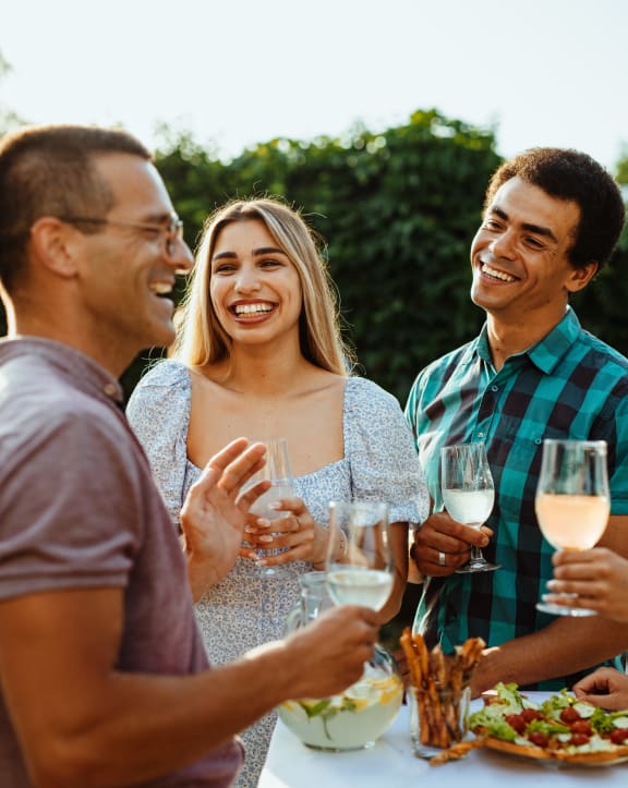a group of people standing around a table with food and drinks at Arbor Ridge, Greensboro