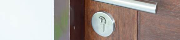 A door with a keypad and a handle.