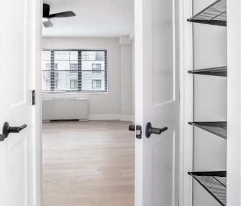 a living room with a bookshelf and a white door