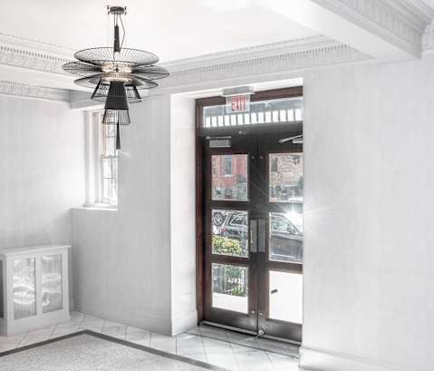 a view of a lobby with a door and a ceiling fan
