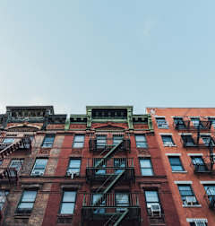 A red brick building with black fire escapes.