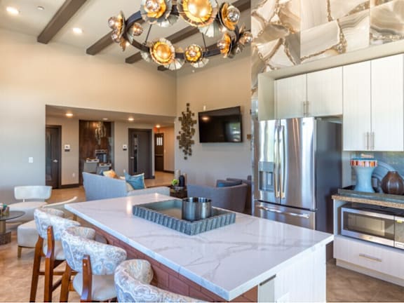 A modern kitchen with a marble countertop and a large island.