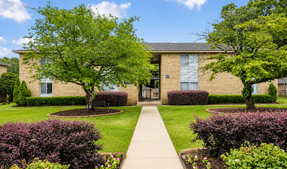 A building with a green lawn in front.