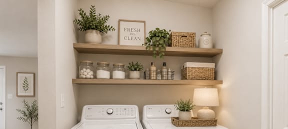 A small laundry room with a washer and dryer.