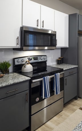a modern kitchen with stainless steel appliances and granite countertops