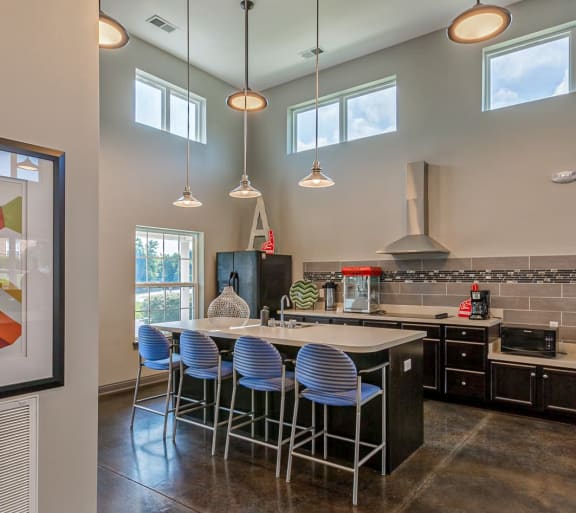 A modern kitchen with a large island and bar stools. at HUB of New Albany Apartments, New Albany