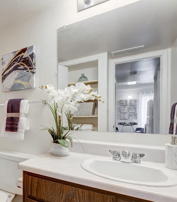 A white bathroom with a white tub, sink, and toilet.