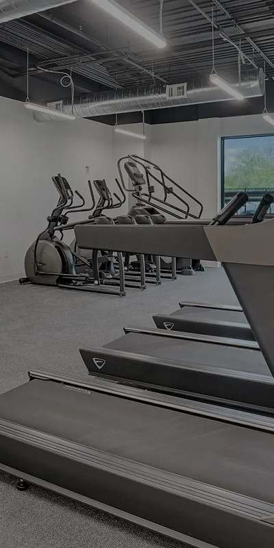 A gym with treadmills and exercise bikes.