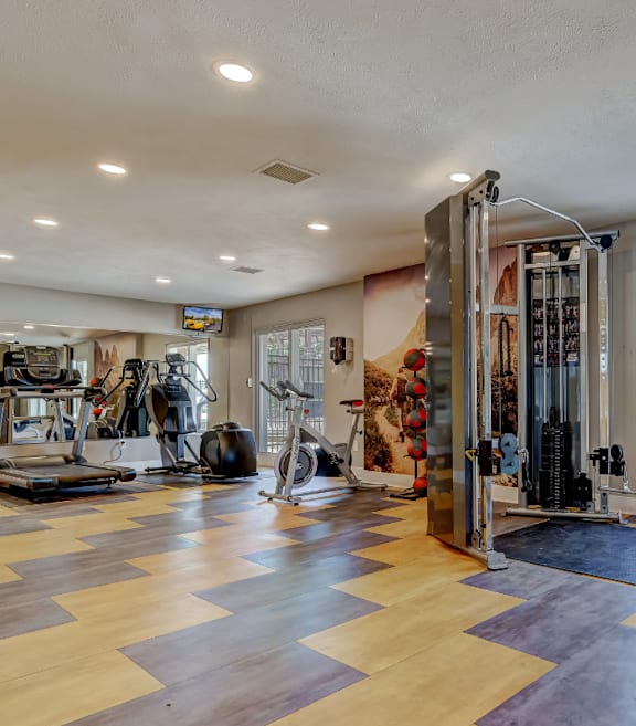 A spacious home gym with a variety of exercise equipment.