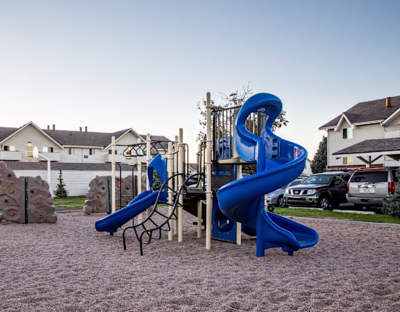 On-site playground with slides and climbing area at pet-friendly Aurora CO apartments.