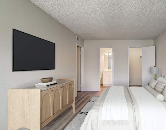 A bedroom with a large bed, a wooden cabinet, and a painting on the wall.