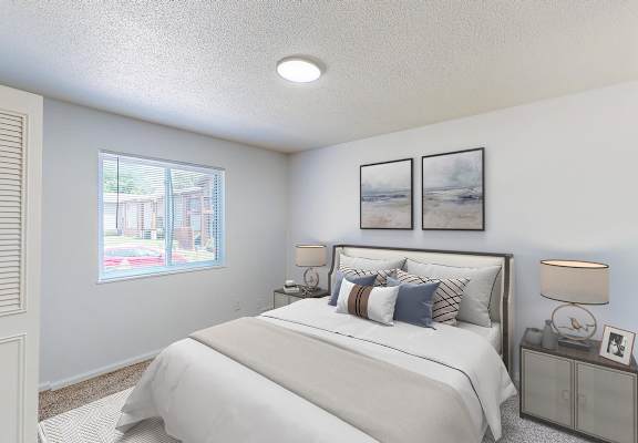 A bedroom with a large bed and a window overlooking a street.