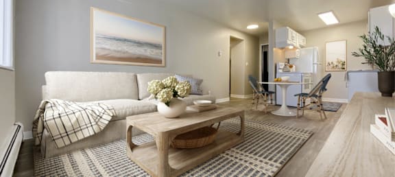 A living room with a couch, coffee table, and a painting of a beach scene on the wall.