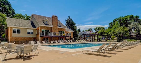 A large house with a pool in front.
