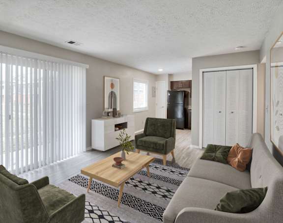 A living room with a green couch, a wooden coffee table, and a potted plant.