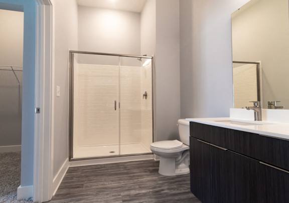 A bathroom with a toilet, sink, and shower.