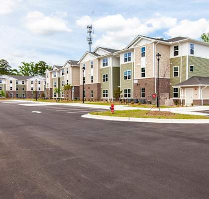an empty parking lot in front of an apartment building