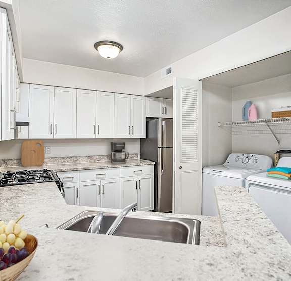 Kitchen with a washer and dryer at Glenn Valley Apartments, Battle Creek