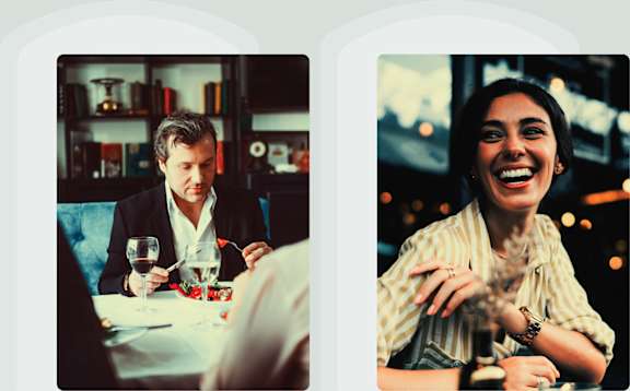 a man and a woman sitting at a table drinking coffee and talking to each other