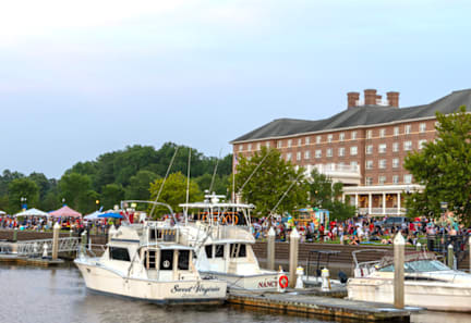 A boat with the name "Sea Adventure" on it is docked at a pier.