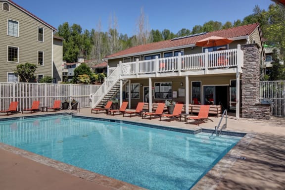 the pool is in front of a house with a resort style pool at 2000 Lake Washington Apartments, WA, 98056