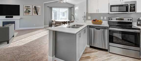 A modern kitchen with stainless steel appliances and white cabinets.