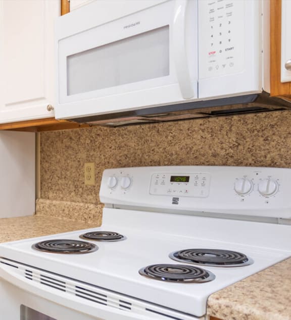 a kitchen with a stainless steel refrigerator and wooden cabinets