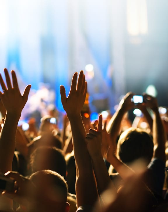 A crowd of people at a concert with their hands raised. at The Dean at Creekview Apartments, Newark, Delaware