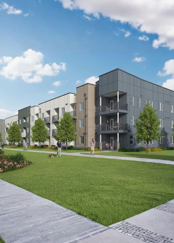 A modern apartment complex with a well-maintained lawn and walking path.