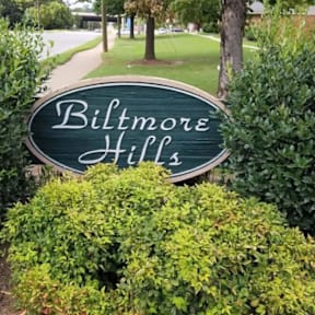 a real estate sign in front of a house photographic print