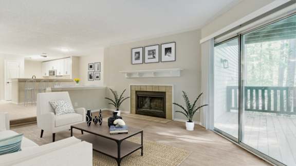 A living room with a fireplace and a glass door leading outside.