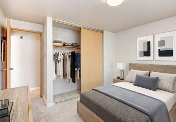 A bedroom with a large bed and a wardrobe.