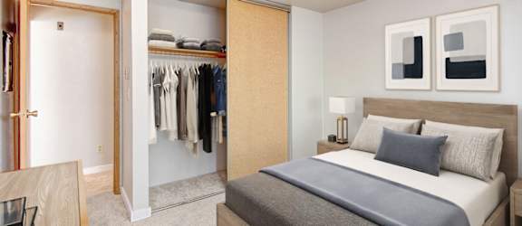 A bedroom with a large bed and a wardrobe.