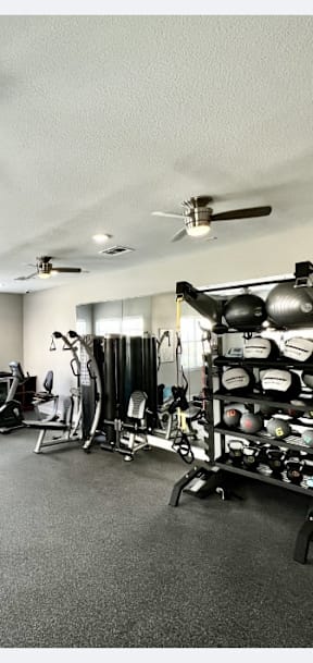 A gym with treadmills, weights, and exercise equipment.