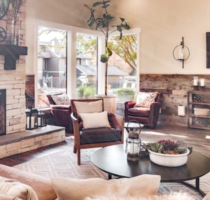 a living room with couches and chairs and a fireplace