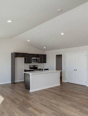 A kitchen with a white counter and a white door. at Two Rivers Home Rentals, Iowa 50266
