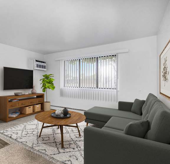 a garden style living room with a couch at Brookside Apartments in Springfield, MI