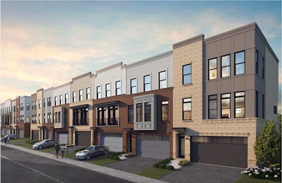 A row of modern townhouses with garages and driveways.